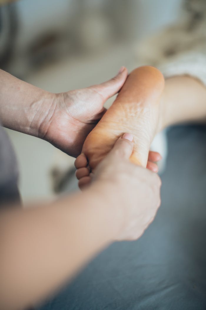 Mastering the First Impression: Your intriguing post title goes here Close-up of hands giving a relaxing foot massage in a spa setting, promoting wellness.