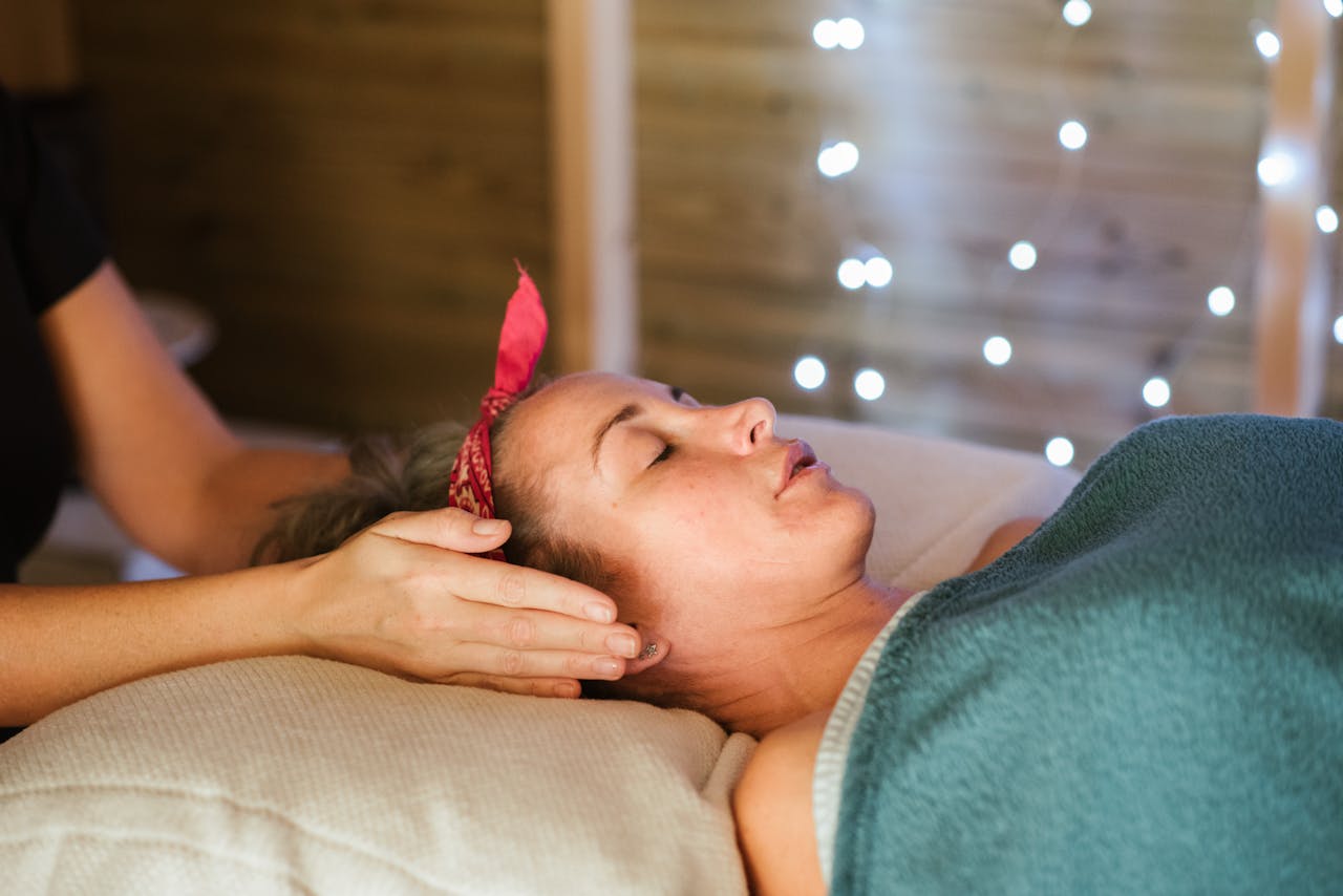 Crafting Captivating Headlines: Your awesome post title goes here Side view of relaxed female patient with closed eyes lying on table under blanket while getting massage reiki during healing session in salon